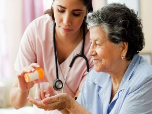 A nurse giving medicine to a patient